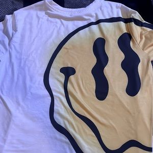 A yellow and white smiley face shirt